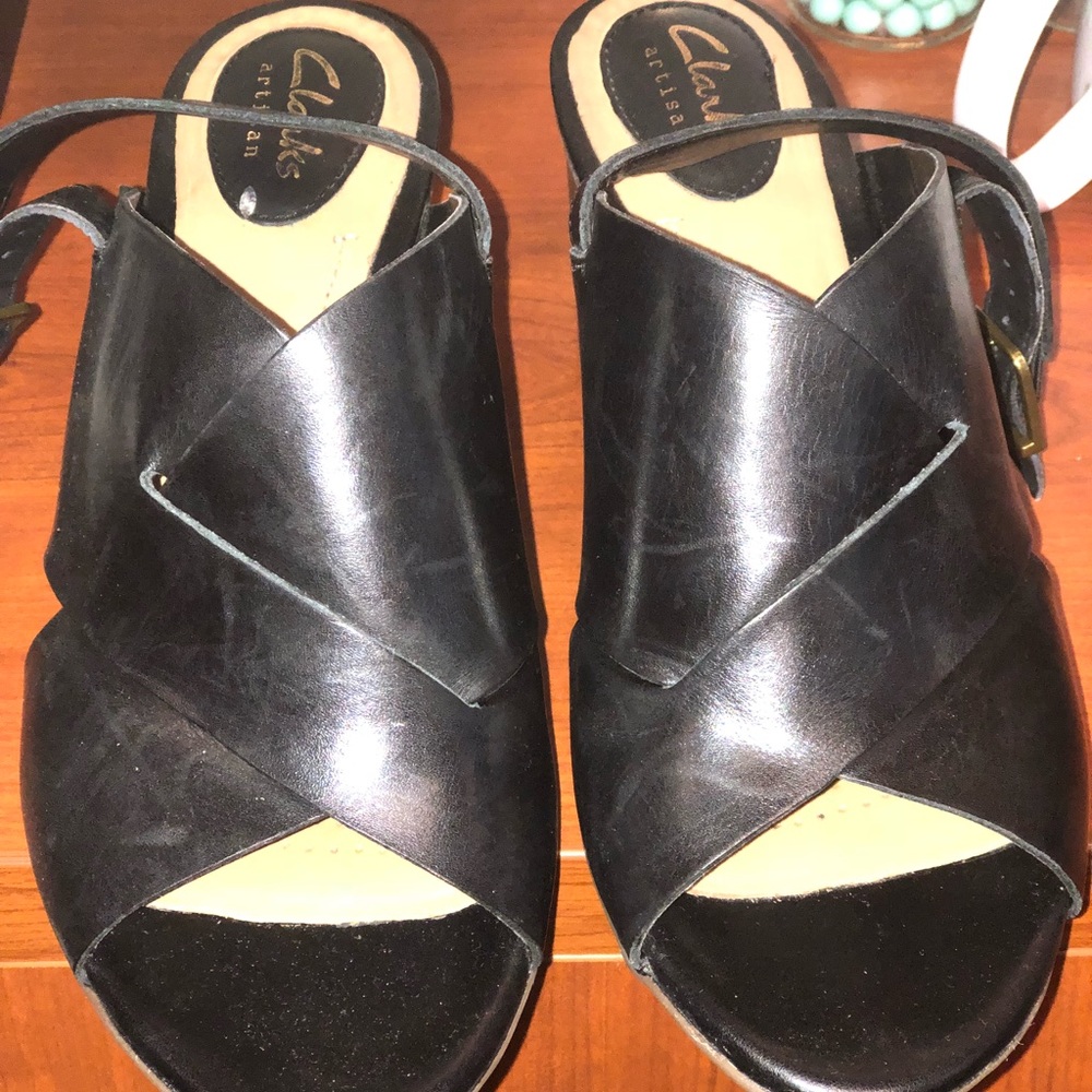 Black leather sandals.